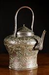 An 18th Century Copper Kettle with repoussé decoration and a wrought iron handle, 16 ins (41 cms) in