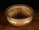 A Copper Repoussé Wine Cooler with gadrooned sides, 8 ins (20 cms) high, 16 ins (41 cms) in