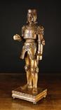 A 16th Century Limewood Carving of a King in Armour standing on a square plinth base, 24 ins (61