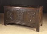 A Good 17th Century Oak Coffer.  The triple panel lid in a channel moulded framework on original