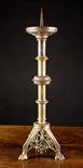 A Large Neo-Gothic Pricket Candlestick with traces of silvering.  The spike centring a scallop-edged