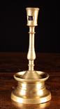 A 16th Century Brass Candlestick.  The candle socket with lateral cut ejector on a tear-drop knopped