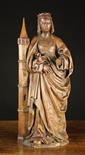 A Late Gothic Oak Carving of Saint Barbara carved in the round.  The crowned figure with her hair