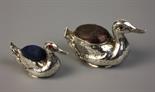 Two Edwardian Silver Pin Cushions in the form of Ducks. The smaller duck set with red stones eyes,