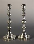 A Pair of Silver Candle Sticks. The knopped stems engraved with bands of scrolling foliage,