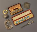 A Collection of Silver Bijouterie; a cased set of five silver buttons (one missing) decorated with