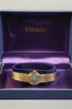 A Nine Carat Gold Tissot Lady's Wrist Watch in case with certificate of origin and guarantee.