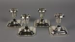 A Set of Four Silver Dwarf Candlesticks hallmarked Birmingham 1930, on square moulded bases with