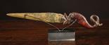 An Ancient & Rare Knife having a gilded blade on a carved mammoth tusk handle in the form of a