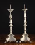 A Pair of Pewter Pricket Candlesticks Circa 1700.  The knopped stems on canted scrolling triform