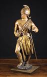 A Polychromed Wood Carving of a Soldier, Circa 1700, wearing a helmet and toga with sword hung