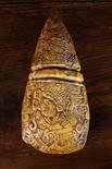 An Antique Carved Mayan Axe Head with intricate decoration, 9 ins (23 cms) in length, 4 ins 910 cms)