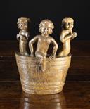 A 16th Century Oak Fragment Carving of Three Young Children in a barrel, 9 ins (23 cms) in height.