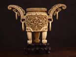 A 19th Century Chinese Ivory Vessel on wooden stand, having a key pattern border and intricate