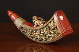 A Chinese Red Lacquered & Gilded Powder Flask. The horn shaped flask surmounted by a carved and