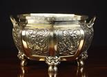 A Large Oriental Polished Bronze Jardiniere. The bulbous octagonal vessel decorated with panels of