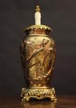 A Large Chinese Gilt Metal Table Lamp. The sides relief cast with Feng Huang birds and foliage,