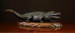 A Dark Patinated Oriental Bronze Study of a Crocodile with a seal mark to belly. Tail (A/F). 16