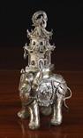 A 19th Century Chinese Bronze Figure of an Elephant with pagoda on it's back, 10¼ ins (26 cms) in