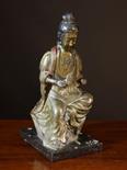 An Antique Chinese Bronze Figure of a seated female holding a scroll in one hand (other hand