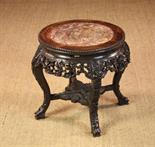 A 19th Century Chinese Hardwood Plant Stand. The round top having a pink marble insert and beaded