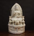 A Large 'Blanc de Chine' Stoneware Shrine Figure of Guanyin sat on a lotus flower surrounded by