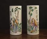 A Pair of Oriental Brush Pots.  The cylindrical vessels painted with calligraphy and figural scenes;