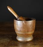 A 17th/18th Century Turned Walnut Treen Pestle and Mortar. The mortar 6¼ ins (16 cms) high, 6 ins (