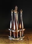 An Early 19th Century Cruet Set comprising of four brown glass 'Alsace' bottles with finialed cork