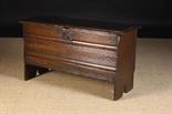 An Early 17th Century Boarded Oak Coffer.  The lid on strap hinges opening to reveal a till at one