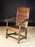 A Late 17th/Early 18th Century Joined Oak Wainscot Chair.  The shaped cresting rail decorated with a