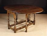 A 17th Century Oak Drop Leaf Dining Table. The oval top on baluster & fillet repeat turned legs