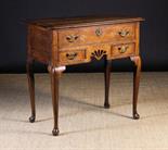 An 18th Century Oak Lowboy.  The top inlaid with an ebony band and having rounded front corners