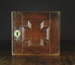 A Small 17th Century Oak Spice Cabinet.  The door having a geometric moulded cruciform panel with