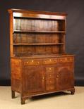 An Early 19th Century Caermarthanshire Oak Dresser of golden brown colour. The rack having two