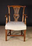 An 18th Century Elm 'Country Chippendale' Armchair.  The cresting rail having outswept terminals