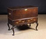 An Early Georgian Oak Chest on Stand.  The boarded chest with a hinged lid edged in applied moulding