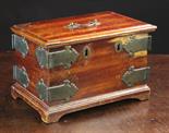 An 18th Century Wooden Strong Box bound in decorative brass corner brackets with a swing handle to