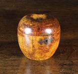 A George III Fruitwood Teacaddy in the form of an apple. The small iron escutcheon with lock (