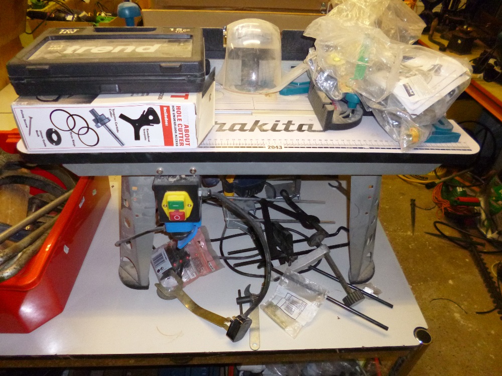 A `Makita` router table, a performance pro 1/2 router bits and