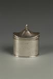 AN EDWARDIAN TEA CADDY of oval form, with reeded borders, knop finial, monogrammed, by James Dixon