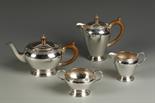 A FOUR PIECE TEA/COFFEE SET, of circular tapering form, with Celtic band decoration, on spreading