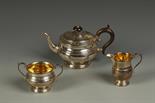 A THREE PIECE TEA SET of circular bellied form, with scroll handles and moulded girdles, the sugar