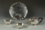 A THREE PIECE TEA SET of shaped rectangular form, with angular handles, on tucked in feet, together