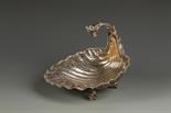A LATE VICTORIAN FRUIT DISH in the manner of Paul de Lamerie, of undulating circular form,