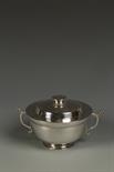 AN EDWARDIAN BOWL AND COVER, the bowl of tapering circular form with scroll handles, tucked in