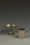 A VICTORIAN CHRISTENING MUG of octagonal form, with scroll handle, engraved with scrolls and