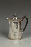 A VICTORIAN HOT WATER POT of shaped oval form, with a scroll handle and bright cut decoration, by