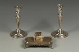 A PAIR OF EDWARDIAN CANDLE STICKS with tapering cylindrical stems and pull-off circular sconces, on