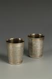 A PAIR OF VICTORIAN BEAKERS of circular form, the bodies decorated with a mottled, textured effect,